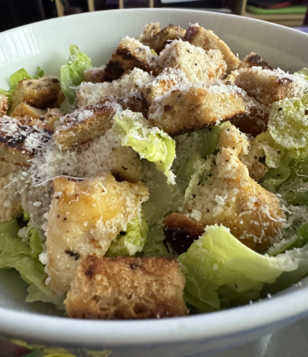 Photo of a caesar salad serving. salad
